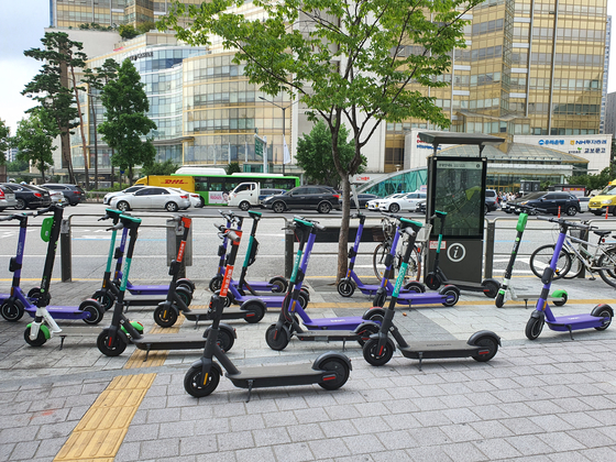 Electric scooters are parked in front of exit 1 of Jamsil Station in southern Seoul. [PARK MIN-JE]